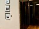 Modern hallway with glass cabinets and framed pictures on the wall