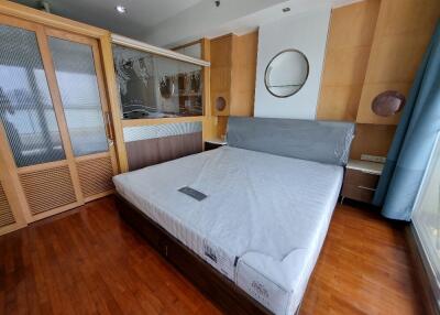 Bedroom with bed, built-in wardrobe, and wooden flooring