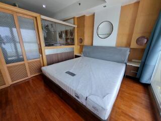 Bedroom with bed, built-in wardrobe, and wooden flooring