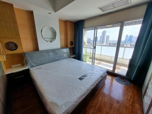 Modern bedroom with large windows and city view