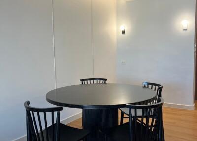 Modern dining area with round table and four chairs