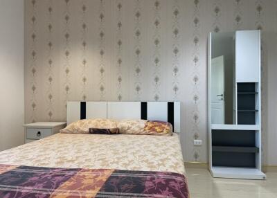 Modern bedroom with a double bed and wardrobe mirror