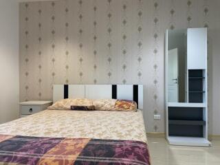 Modern bedroom with a double bed and wardrobe mirror