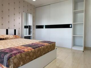 Modern bedroom with bed, wardrobe, and mirror