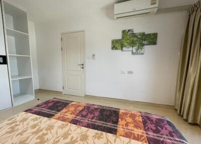 Bedroom with art on the wall and air conditioner