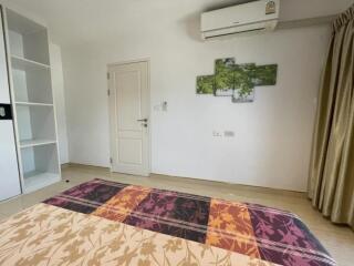 Bedroom with art on the wall and air conditioner