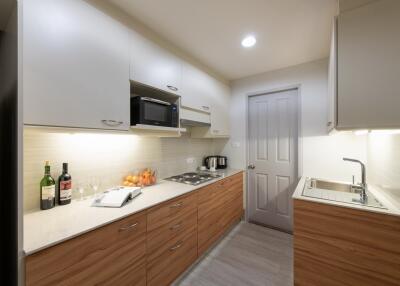 Modern kitchen with wooden cabinets and appliances