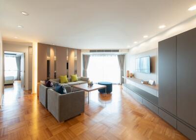 Modern, spacious living room with wooden flooring and contemporary furnishings.