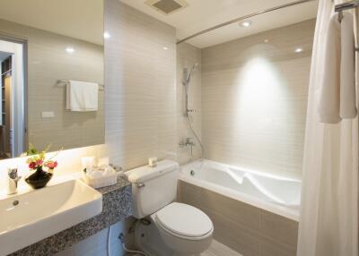 Modern bathroom with sink, toilet, and bathtub