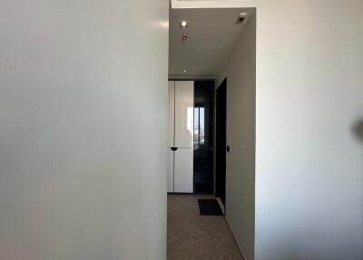 View of a hallway with a closet and doorway