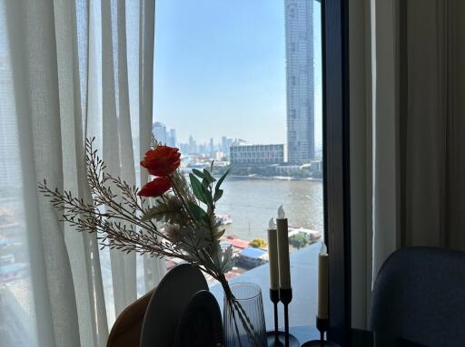 Living room with a view of the river and cityscape