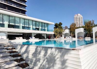 Luxury outdoor pool area with modern building