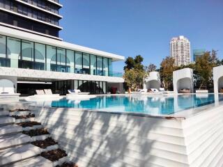 Luxury outdoor pool area with modern building