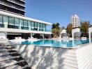 Luxury outdoor pool area with modern building