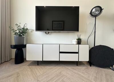 Modern living room setup with wall-mounted TV and minimalist furniture