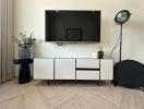 Modern living room setup with wall-mounted TV and minimalist furniture