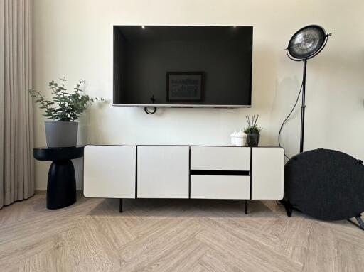 Modern living room setup with wall-mounted TV and minimalist furniture