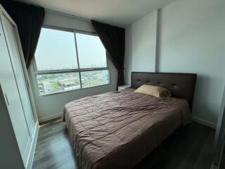 Modern bedroom with large window and city view