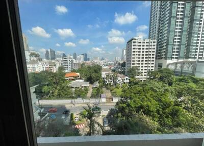 City skyline and greenery view through a window