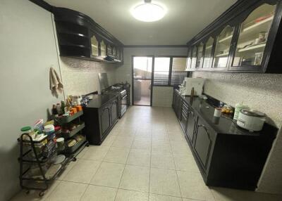 Spacious kitchen with black cabinetry and modern amenities