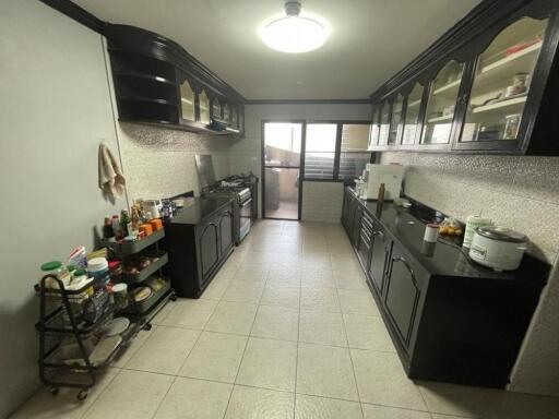 Spacious kitchen with black cabinetry and modern amenities