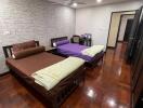 Bedroom with twin beds and wooden flooring