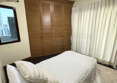 Bedroom with wardrobe and window view