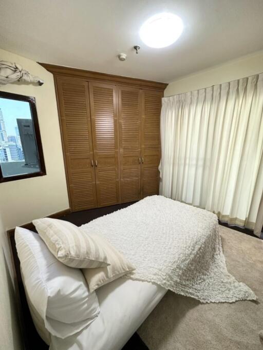 Bedroom with wardrobe and window view