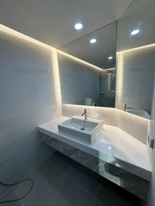 Modern bathroom with large mirror and floating sink