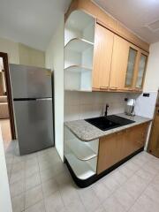 Modern kitchen with wooden cabinets, countertops, and appliances