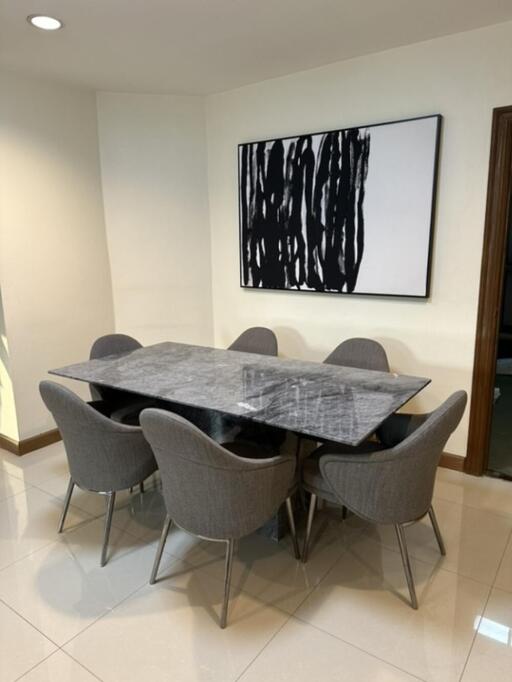 Modern dining room with marble table and abstract art