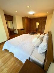 Spacious bedroom with wooden flooring and built-in wardrobe