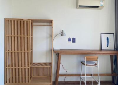 Bedroom with wooden wardrobe, desk, and chair