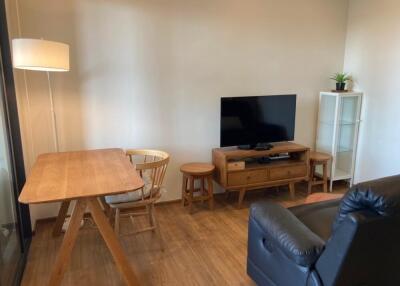 Living room with wooden furniture and television