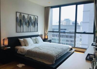 Modern bedroom with large windows and city view