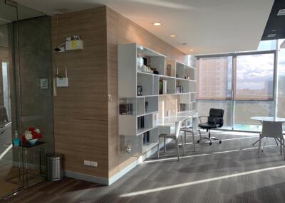 Modern living room with large windows and built-in shelving