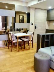 Modern living and dining area with wooden floors and stylish furniture