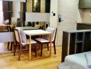 Modern living and dining area with wooden floors and stylish furniture