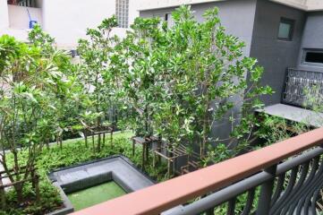 View of a well-maintained outdoor garden with green trees and plants