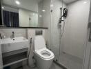 Modern bathroom with sink, toilet, and shower