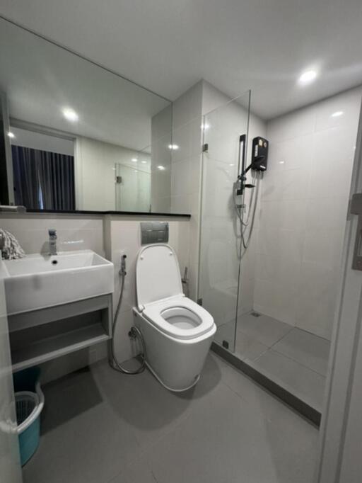 Modern bathroom with sink, toilet, and shower