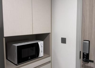 Compact kitchen corner with microwave in modern cabinetry