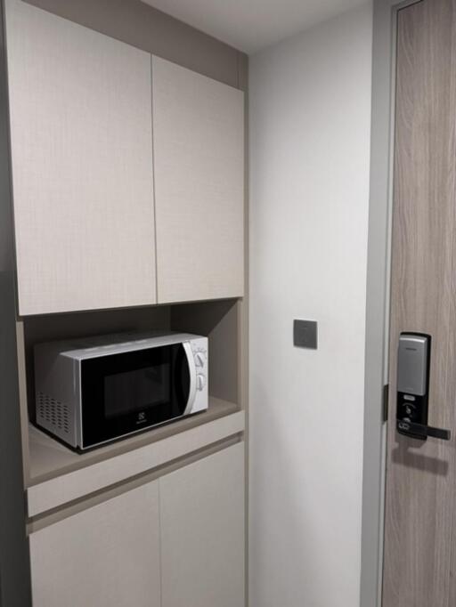 Compact kitchen corner with microwave in modern cabinetry