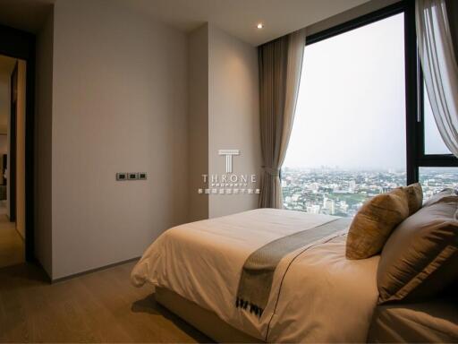 Modern bedroom with a large window and city view