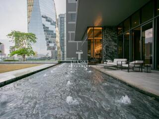 Modern outdoor patio with water feature and cityscape view