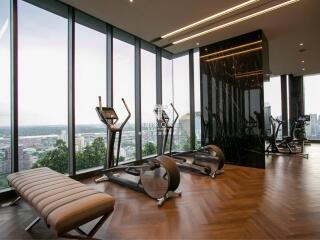 Modern gym with large windows overlooking a cityscape