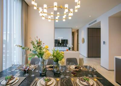 Elegant dining area with modern chandelier and table settings