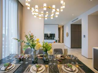 Elegant dining area with modern chandelier and table settings