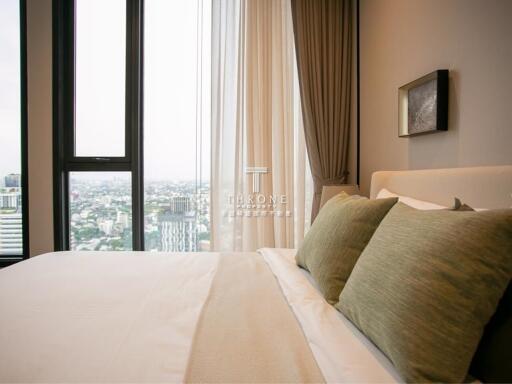 Modern bedroom with large window and city view