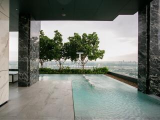 Outdoor infinity pool area with a city view